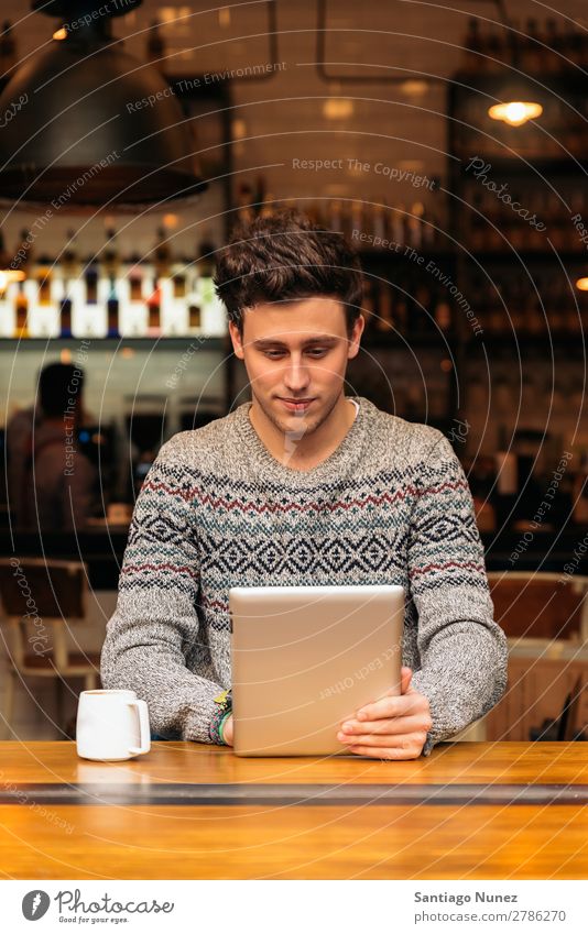 Businessman using his laptop in the Coffee Shop. Man Friendliness Youth (Young adults) Portrait photograph Human being Lifestyle Communication PDA Cellphone