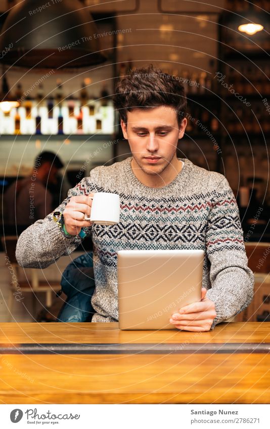 Businessman using his laptop in the Coffee Shop. Man Friendliness Portrait photograph Youth (Young adults) Human being Lifestyle Communication PDA Cellphone