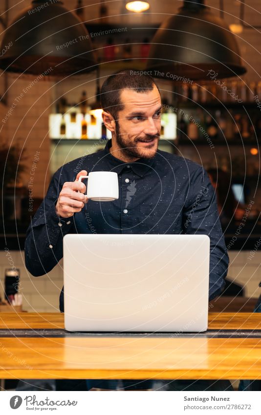 Businessman using his laptop in the Coffee Shop. Man Friendliness Youth (Young adults) Portrait photograph Human being Lifestyle Communication PDA Cellphone