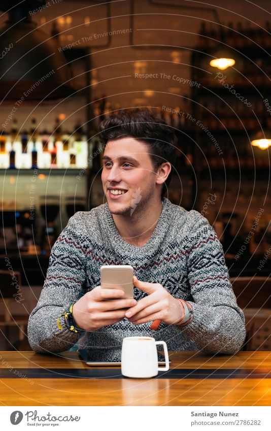 Businessman using his mobile in the Coffee Shop. Man Friendliness Portrait photograph Youth (Young adults) Human being Lifestyle Communication PDA Cellphone