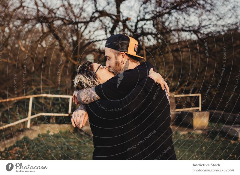 Young couple hugging and kissing in forest Couple Embrace Kissing Forest Park Youth (Young adults) Eyeglasses bearded Man Woman embracing Hipster Walking