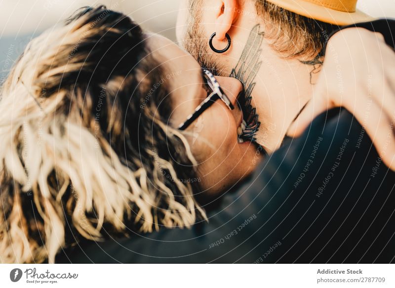 Happy couple hugging and kissing near tree in park Couple Embrace Park Tree embracing Back Wood Forest Youth (Young adults) Cheerful bearded Man Woman Joy