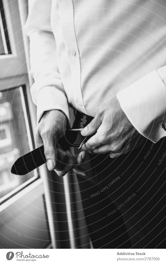 Man buttoning belt on pants Belt Pants Hand Leather Black Window Style Clothing Elegant Wear Fashion Accessory Gentleman White Waist Shirt strap Guy Luxury