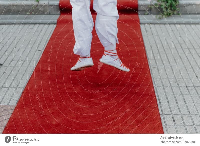Person in white cloth and gym shoes jumping on red carpet Red carpet Human being Suit Cloth White Jump Legs Street Wear Carpet Lifestyle Luxury Success