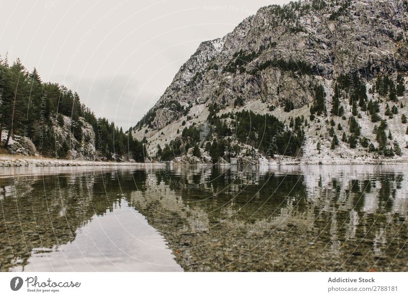 Wonderful lake between hills in snow and cloudy sky Lake Hill Snow Sky Pyrenees Clouds Water Surface Mountain Height Tree Amazing Vantage point Heaven Glade