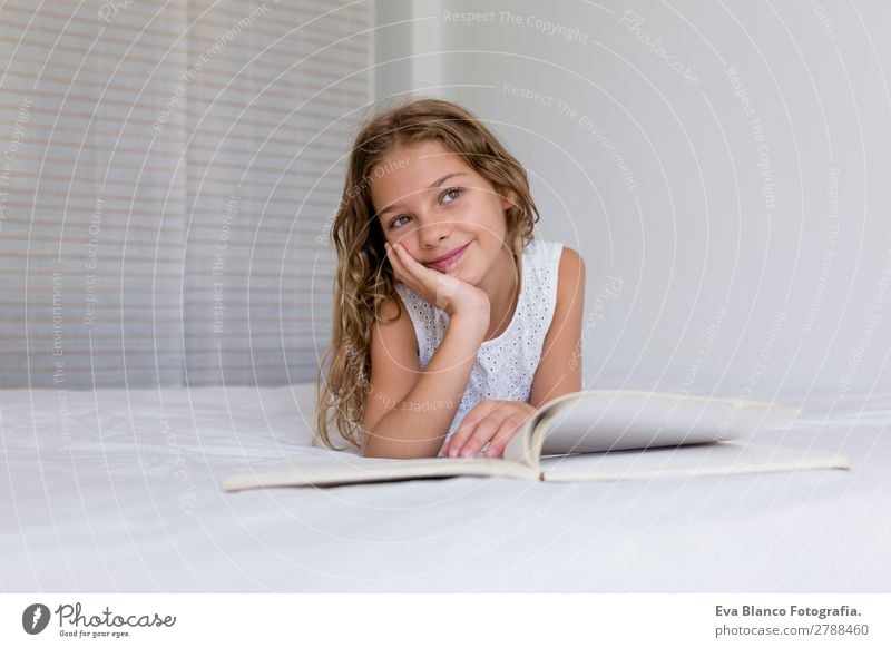 beautiful kid girl reading a book on bed Lifestyle Joy Beautiful Relaxation Leisure and hobbies Reading House (Residential Structure) Bed Bedroom Child School