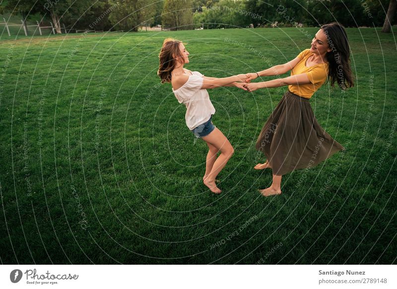 Beautiful women smiling and having fun. Woman Picnic Friendship Youth (Young adults) Hand Playing Park Happy Summer Human being Joy Funny Hold Teamwork