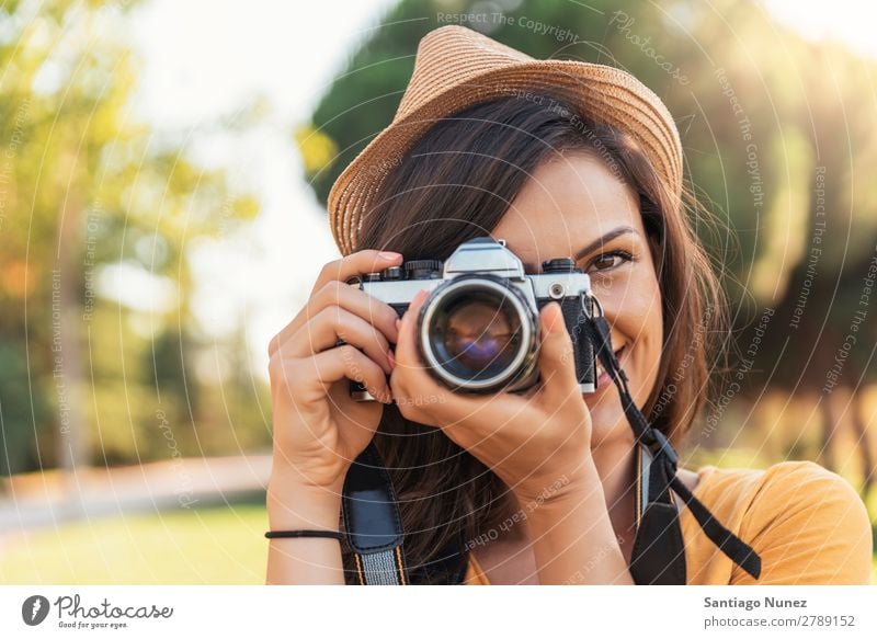 Smiling young woman using a camera to take photo. Photographer Woman Photography Camera Youth (Young adults) Girl Digital White Leisure and hobbies 1 Take