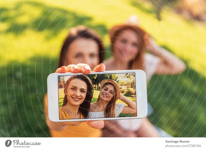 Beautiful women taking a selfie portrait in the park. Woman Picnic Friendship Youth (Young adults) Happy Summer Human being Joy Mobile PDA Telephone Solar cell