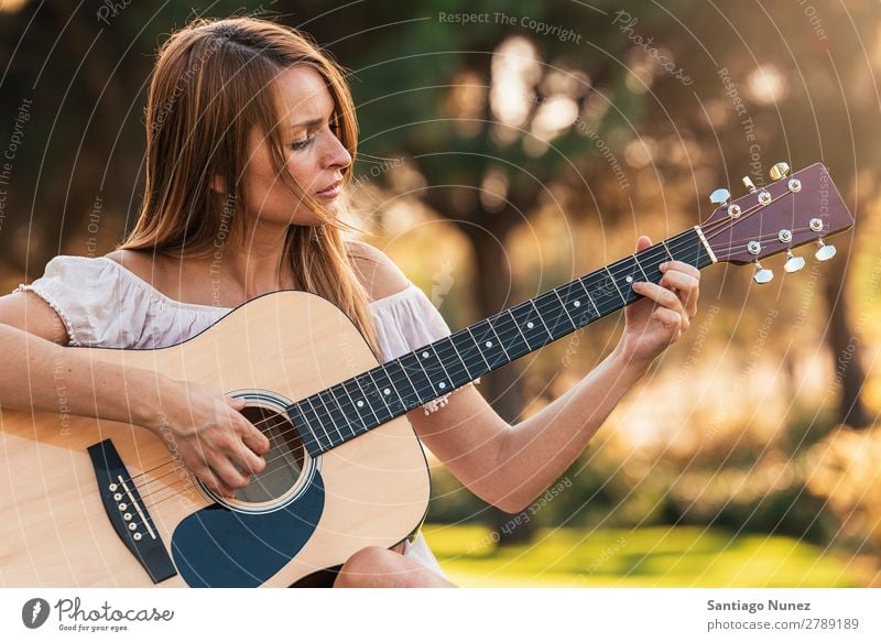 Beautiful woman playing guitar. - a Royalty Free Stock Photo from Photocase