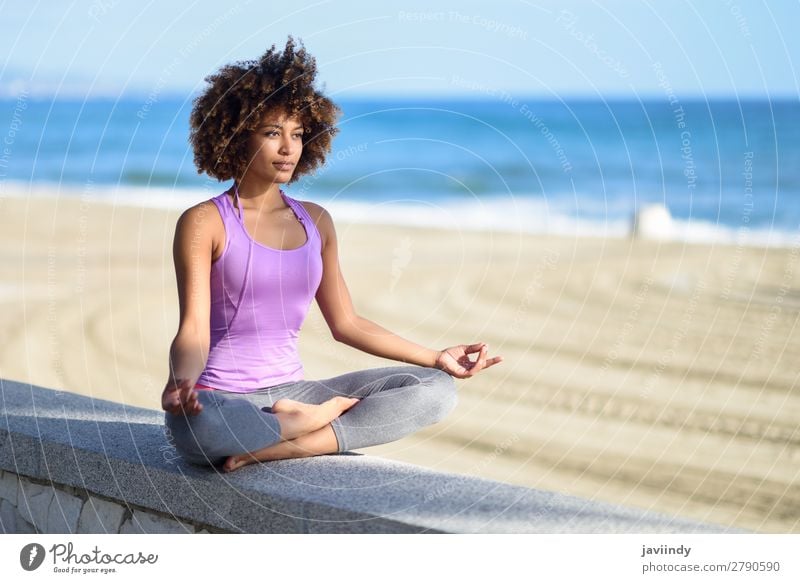 Black woman, afro hairstyle, doing yoga in the beach Lifestyle Beautiful Body Hair and hairstyles Wellness Relaxation Meditation Leisure and hobbies Beach Ocean