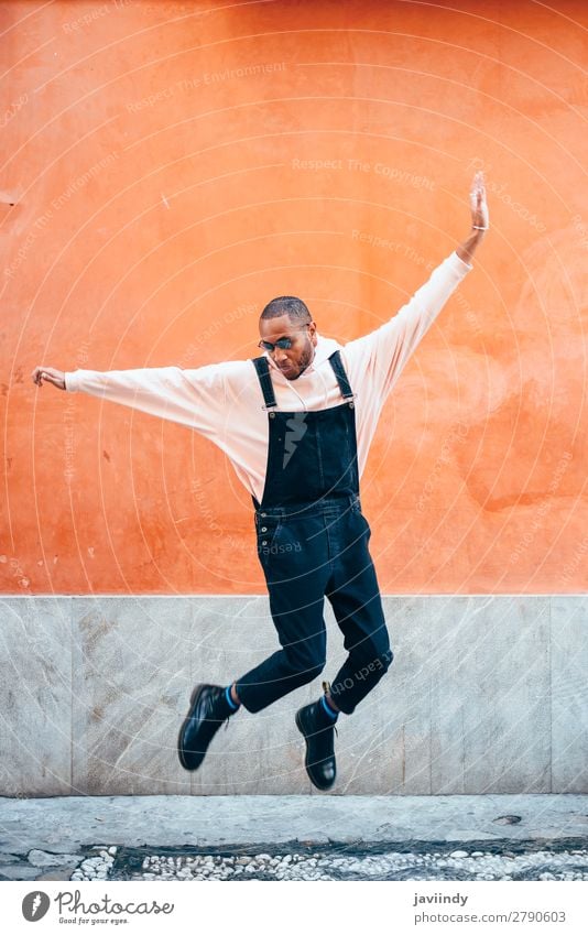 Young black man wearing casual clothes jumping outdoors Lifestyle Joy Happy Beautiful Human being Masculine Young man Youth (Young adults) Man Adults 1