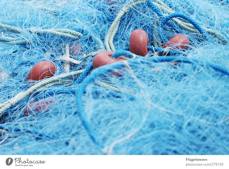 Used fishing nets on a pier. - a Royalty Free Stock Photo from