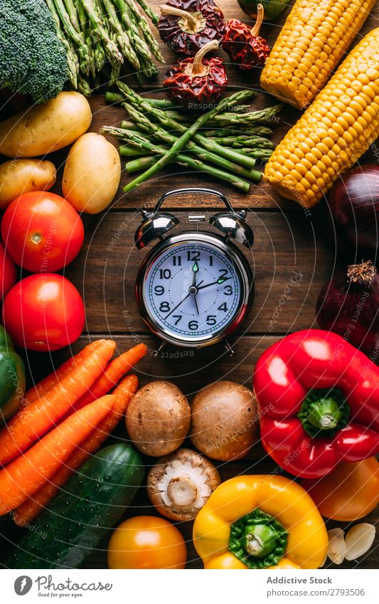 Vegetables lying around alarm clock Alarm clock Time Table Diet Conceptual design Food Healthy Nutrition Organic Vegan diet Set assorted Difference Mature Fresh