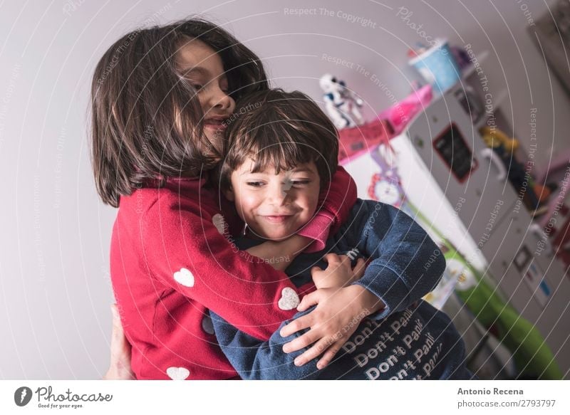 Brother and sister in great hug in lifestyle image Lifestyle Playing Kitchen Child Baby Toddler Boy (child) Sister Family & Relations Smiling Love Stand Cute