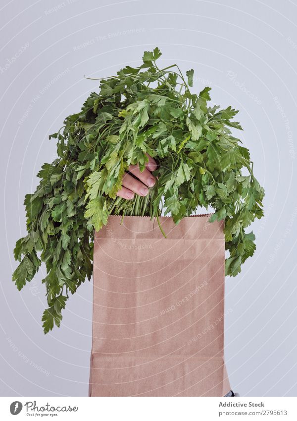 Person hand reached out from packet and holding parsley Human being Hand Package Vegetable Food Bag Craft (trade) Paper Conceptual design Fresh Markets Healthy