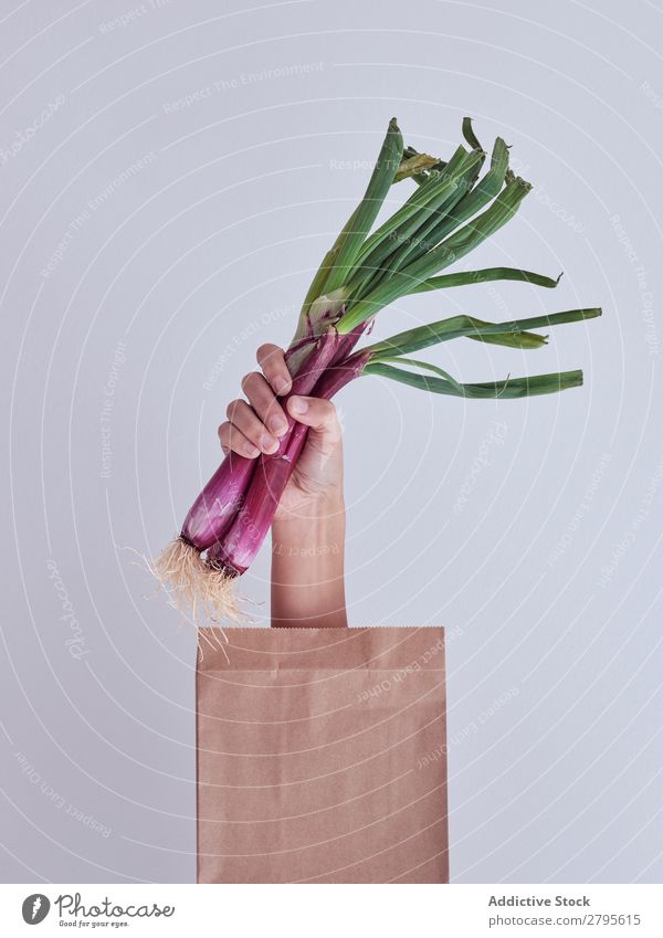 Person hand reached out from packet and holding red leek Human being Hand Package Vegetable Food Bag Craft (trade) Paper Conceptual design Fresh Markets Healthy