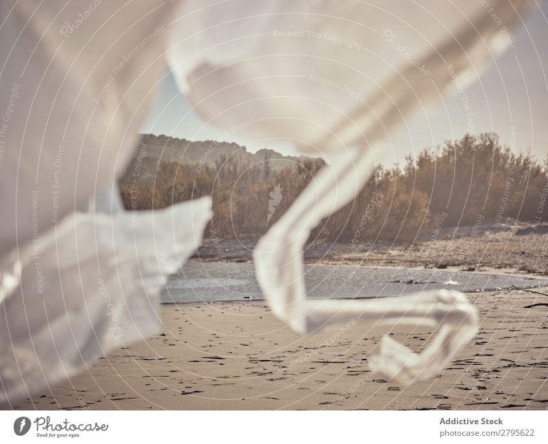 Girl entangled in waving textile on river coast River Coast Child Hand Side Wind Conceptual design Sand Landscape Beach Help White Water Sun Joy Happiness