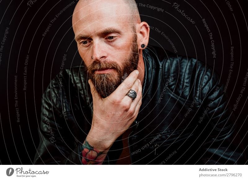 Pensive young bearded guy Man Hipster Tattoo Bald or shaved head Youth (Young adults) Guy Considerate scratching Leather jacket Hand Easygoing handsome