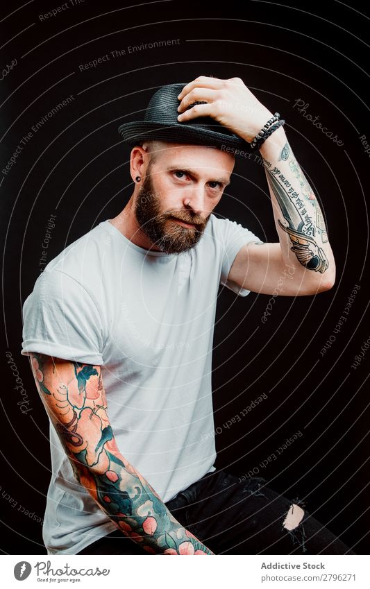 Smiling young guy in hat Man Hipster Tattoo Youth (Young adults) Guy bearded Hat T-shirt Hand Cheerful Easygoing Happy handsome Cool (slang) Style Hip & trendy