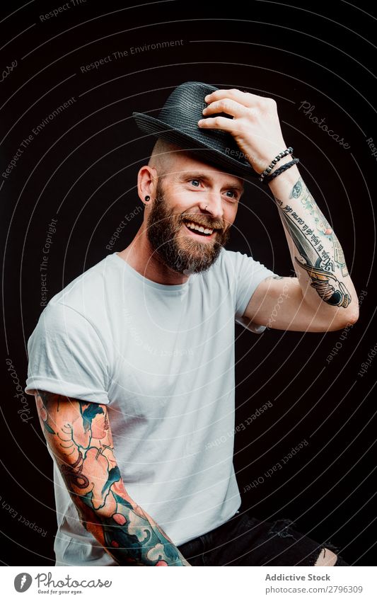 Smiling young guy in hat Man Hipster Tattoo Youth (Young adults) Guy bearded Hat T-shirt Hand Cheerful Easygoing Happy handsome Cool (slang) Style Hip & trendy