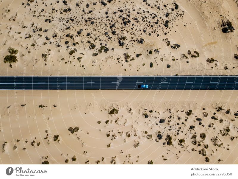 Car driving on road in picturesque desert Desert Spain Aircraft drone view Fuerteventura las palmas Vacation & Travel Street Remote Empty Picturesque