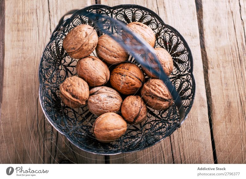 Ornamental basket with walnuts Basket Table Metal Healthy Natural Ingredients Snack Organic Tasty Delicious yummy Fresh bunch Heap Collection composition Wood
