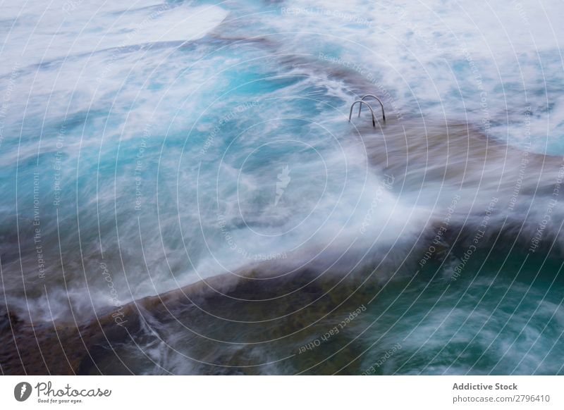 Stone shore with ladder between water Coast Water Ladder Foam hierro island Canaries Spain Ocean Surface Rock Splash Wonderful Amazing Natural Wave Nature