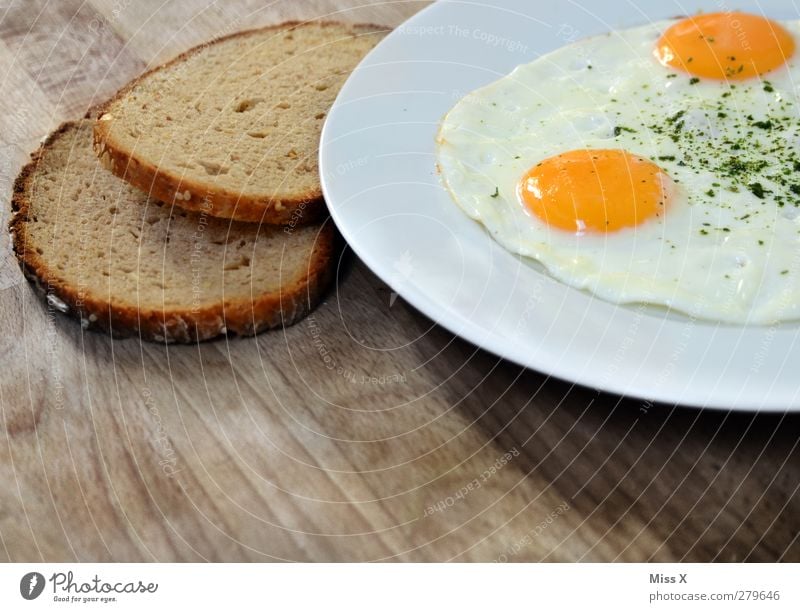 breakfast Food Bread Nutrition Breakfast Lunch Dinner Plate Delicious Yellow White Fried egg sunny-side up Hen's egg Slice of bread Wooden table Rustic