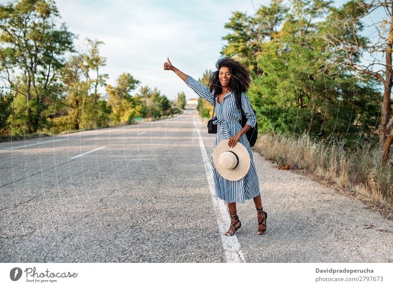 Happy black woman hitchhiking with thumbs up Woman Vacation & Travel Backpacking Ethnic Adventure Street Lift Hitchhike auto stop Trip Black Smiling African