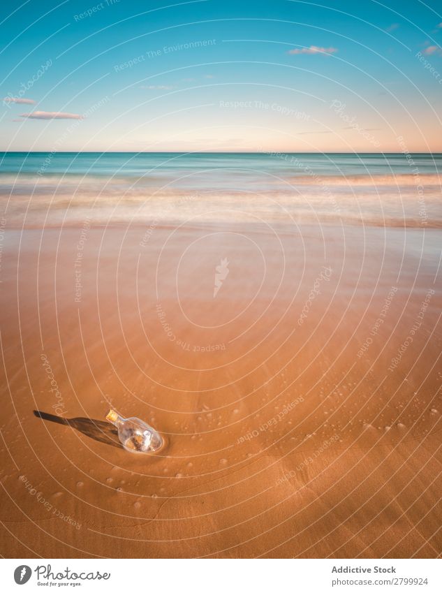 Bottle in sand near sea Letters (alphabet) Sand Ocean Coast Sky Beach Summer Water Vacation & Travel Trip Tourism Deserted Communication Paradise Harmonious