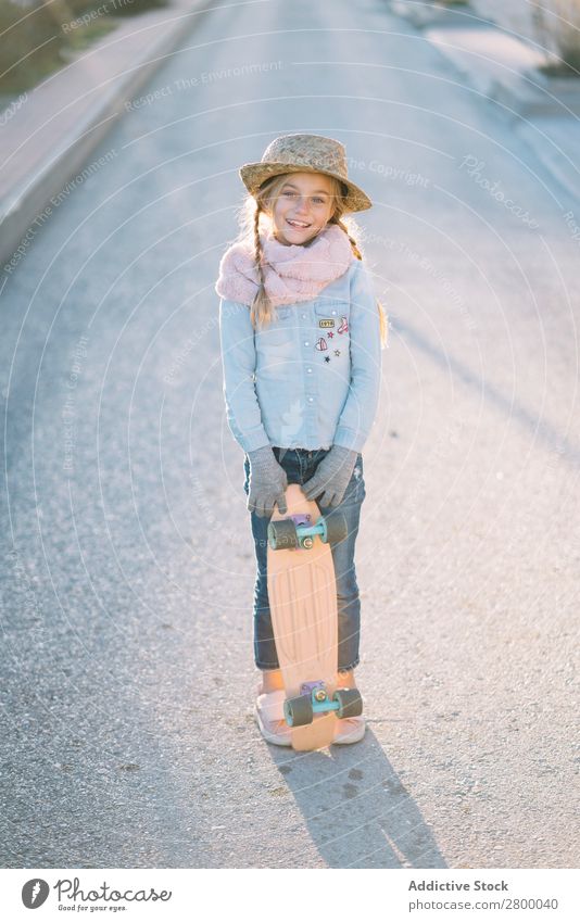 Stylish girl with skateboard on street Girl Blonde Skateboard Street Suburb Style Stand Sunbeam Day Child Hip & trendy Easygoing Lifestyle Leisure and hobbies