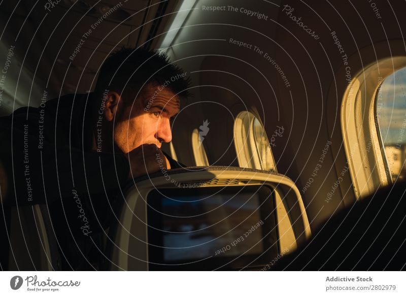 Thoughtful man looking out plane window Man Window Considerate Airplane Story Adults Vacation & Travel Passenger Safety (feeling of) Seat Transport Pensive