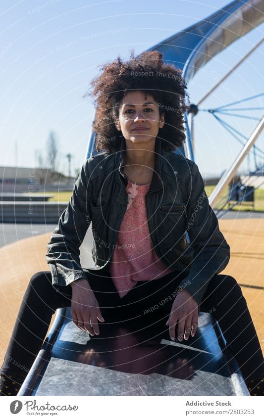 Woman with afro hair jumping down a slide. Adults African American Beautiful Black Farm Flag Girl Happy Hold Model Human being Stars states Wrap