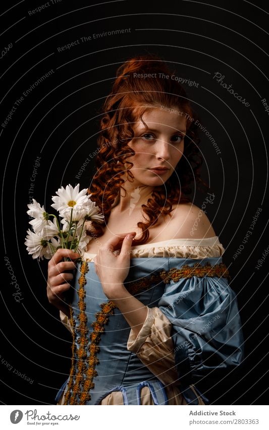 Beautiful woman in medieval clothing Woman Red-haired Baroque Dress Hold Flower daisies Carnival Renaissance Princess Royal masquerade Fantasy Clothing