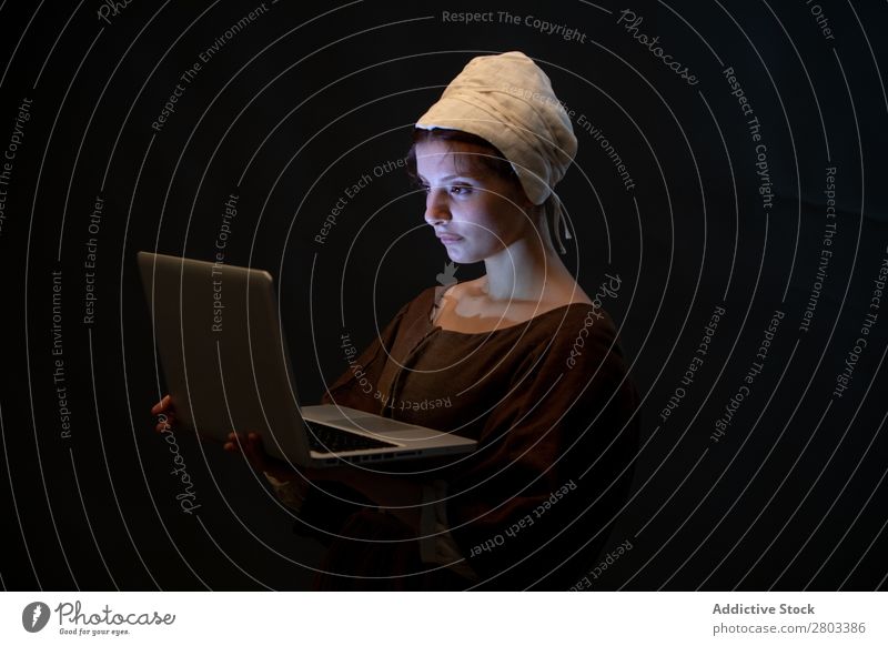 Medieval maid with laptop medieval Notebook using Conceptual design Woman Closed eyes Clothing historical Dress Costume maiden Car Hood Renaissance Vintage