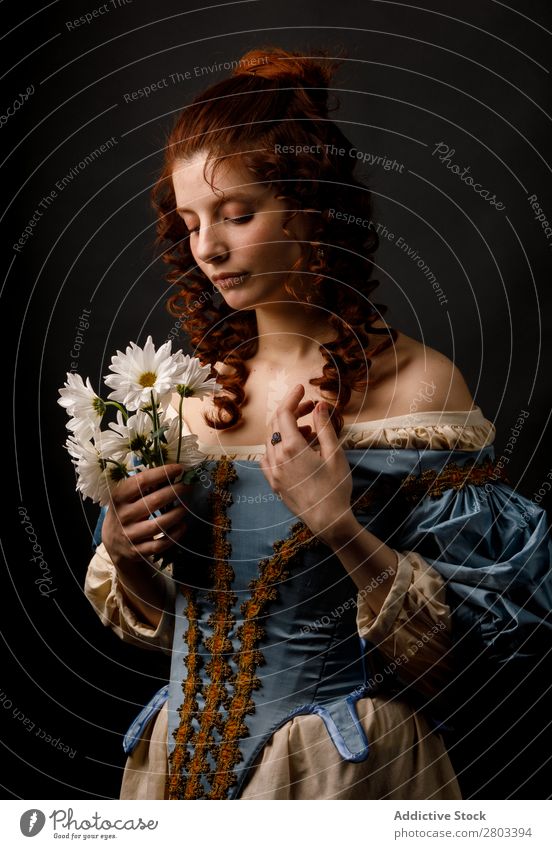 Baroque woman with closed eyes holding flowers Woman Flower daisies Red-haired Corkscrew Closed eyes Dress medieval Carnival Renaissance Princess Royal