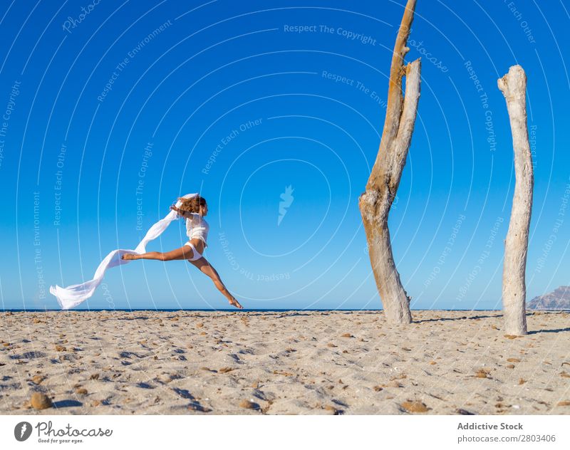 Woman jumping with pareo on beach Beach Rest Jump Summer Vacation & Travel Youth (Young adults) Relaxation Lifestyle Ocean Beautiful Trunk Blue sky