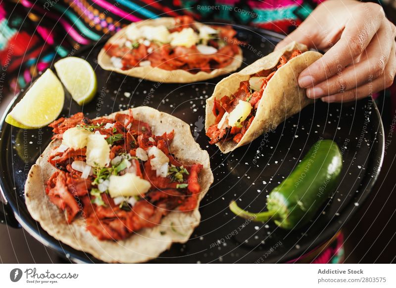 Crop hand holding taco al pastor Woman Mexicans Food Flat bread Meat Dish Lunch Cooking Room Home Spicy Tradition Delicious Tasty yummy delectable palatable