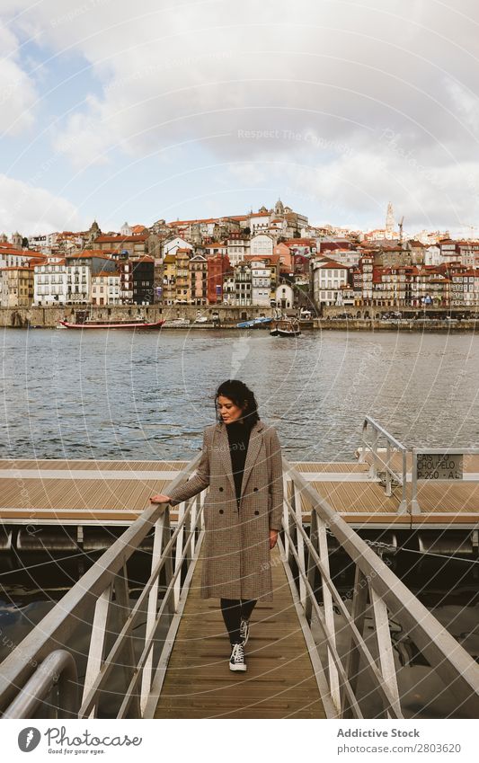 Elegant woman standing on pier in old city Woman Jetty City River Old Stand Clouds Sky Porto Portugal Vacation & Travel Trip Tourism Wanderlust Embankment Water