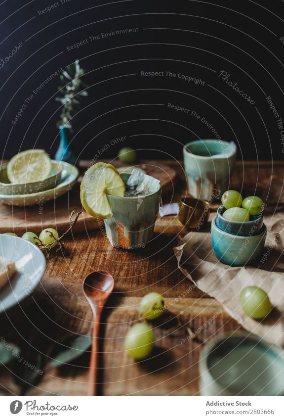 Arrangement of ceramic utensil on wood table Table Bunch of grapes Design Rustic Fresh Lemon Artisan Fruit plates Wood Creativity Natural Self-made