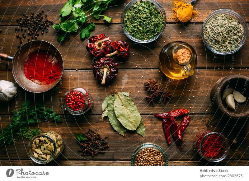 Spices and oil on table Herbs and spices Oil Table assortment Cooking Ingredients Set Fresh Dill Parsley Garlic anise turmeric Cardamom Coriander Chili