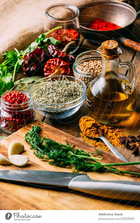 Spices and oil near knife Herbs and spices Oil Knives Table assortment Cooking Ingredients Set Fresh Dill Parsley Garlic anise turmeric Cardamom Coriander Chili