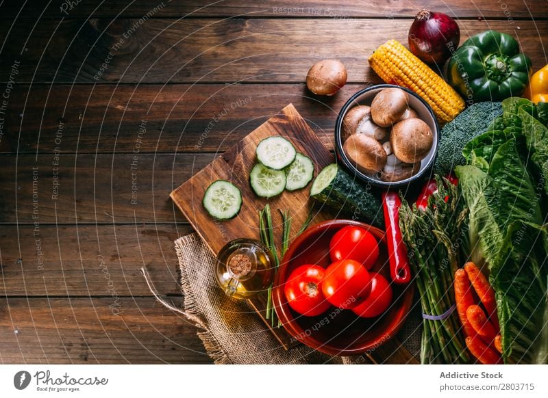 Vegetables and utensils on kitchen table Fresh Vitamin flat lay Oil composition Vertical corn Onion Ingredients Knives Pepper Bird's-eye view Food Cucumber Diet