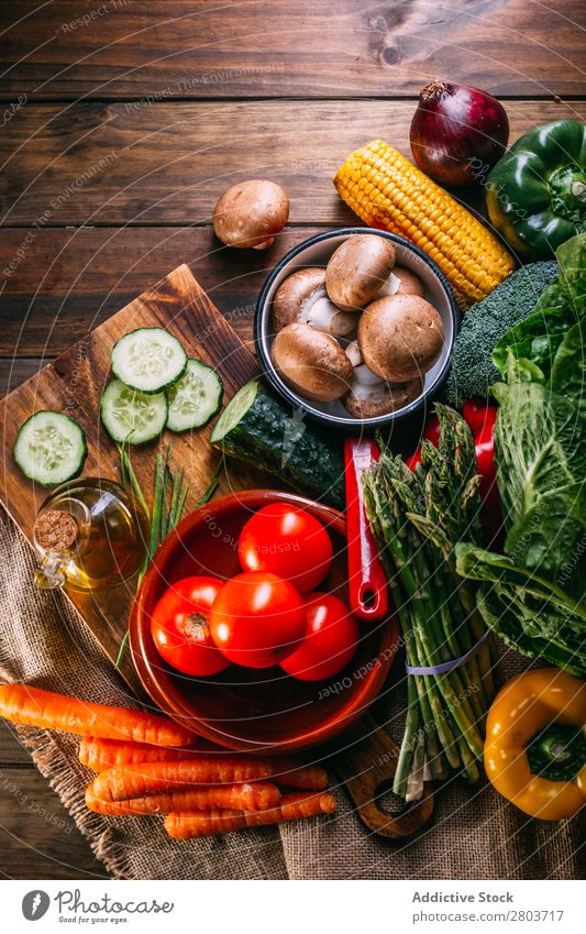Vegetables and utensils on kitchen table Fresh Vitamin flat lay Oil composition Vertical corn Onion Ingredients Knives Pepper Bird's-eye view Food Cucumber Diet