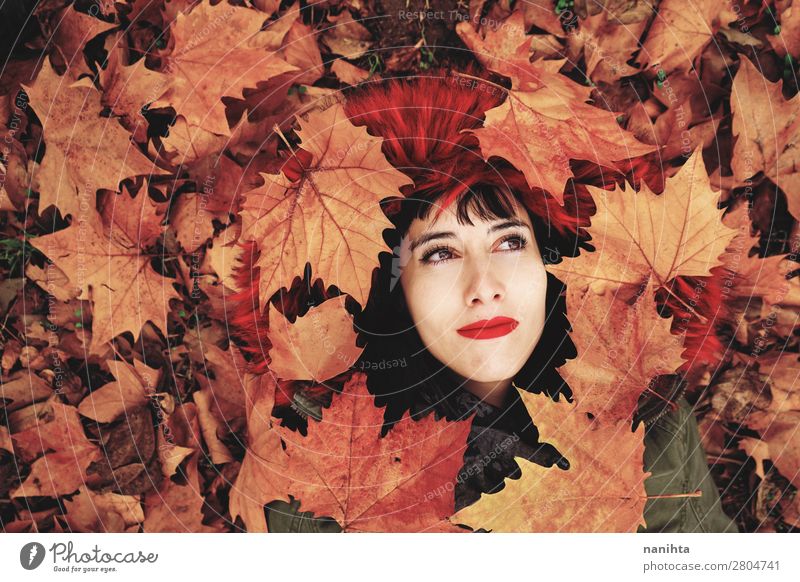 Young woman lying down in the floor full of autumn leaves Lifestyle Style Joy Beautiful Face Wellness Well-being Calm Leisure and hobbies Human being Feminine