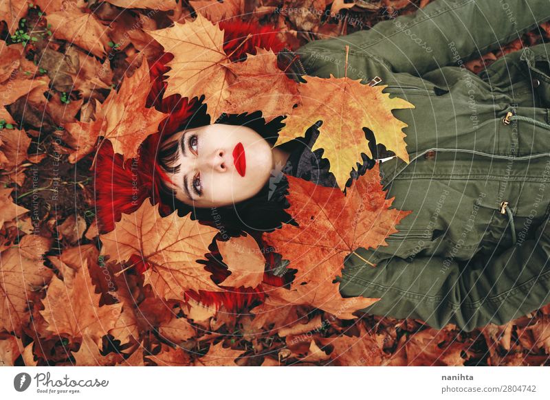 Young woman lying down in the autumn floor Lifestyle Style Face Wellness Relaxation Calm Leisure and hobbies Human being Feminine Woman Adults
