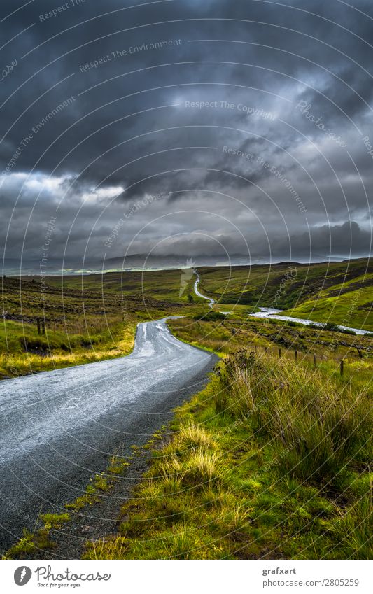 Road through countryside on the Isle of Skye in Scotland Adventure Beginning Loneliness Narrow Far-off places River Direct Storm clouds Great Britain Highlands