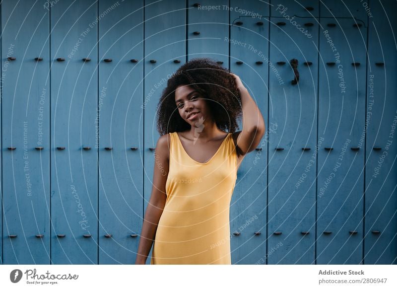 Gorgeous black woman in dress on street Woman Door Blue Black Dress Curly Town To enjoy Barefoot Ethnic African-American Afro Beautiful tender Body