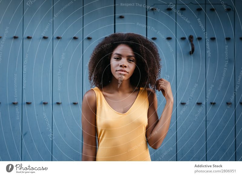 Gorgeous black woman in dress on street Woman Door Blue Black Dress Curly Town To enjoy Barefoot Ethnic African-American Afro Beautiful tender Body